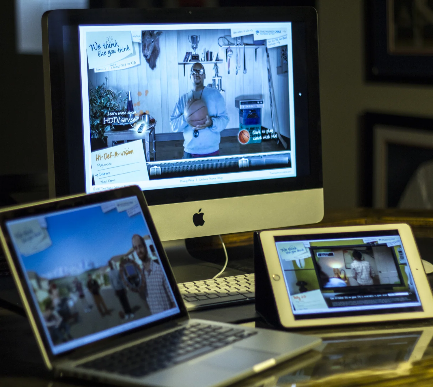 Hi-Def-A-Vision experience shown on iMac, laptop, and iPad
